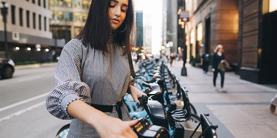 girl renting a city bike from a bike stand. What can CBD do to improve health and wellness in women? 